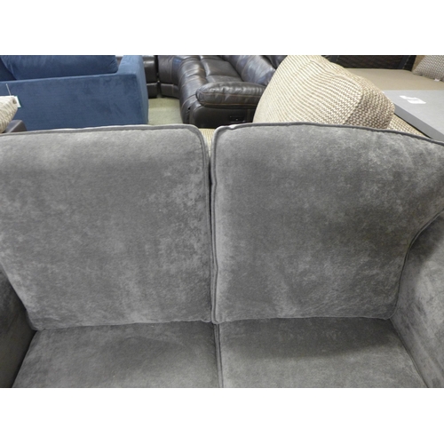 1997 - A grey upholstered two seater sofa - damaged leg