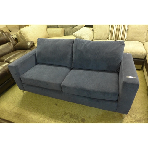 1998 - A blue velvet upholstered three seater sofa - stained on side