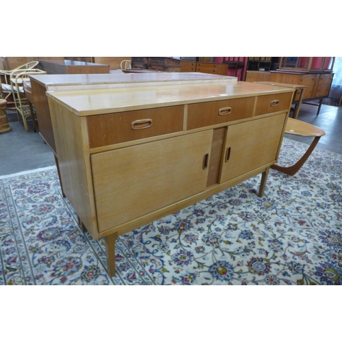 29 - A light oak sideboard