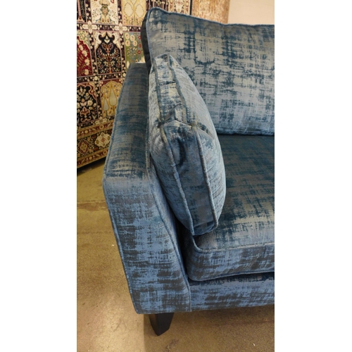 1301 - An ocean blue velvet Barker and Stonehouse three seater sofa