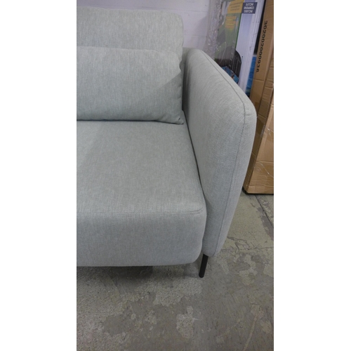 1310 - An olive upholstered three seater sofa