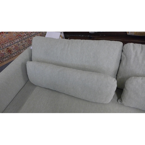 1310 - An olive upholstered three seater sofa