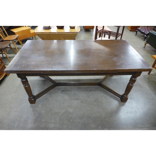 91 - A 17th Century style carved oak extending refectory table, 76cms h, 183cms l, 92cms w