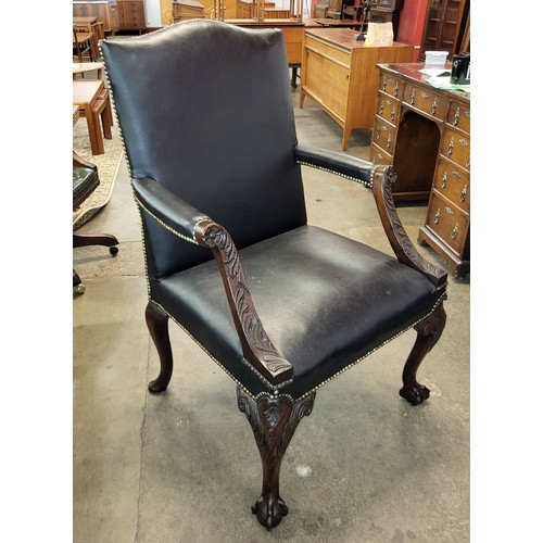 125 - A Chippendale Revival carved mahogany and black leather Gainsborough chair