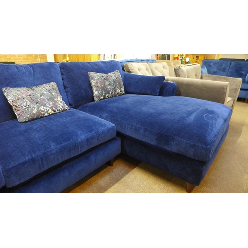 1354 - A blue velvet L shaped sofa with three contrasting scatter cushions