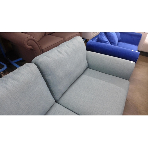 1371 - An aquamarine upholstered three seater sofa - RRP £1099