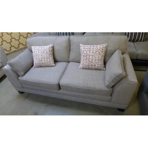 1420 - A light grey upholstered three seater sofa