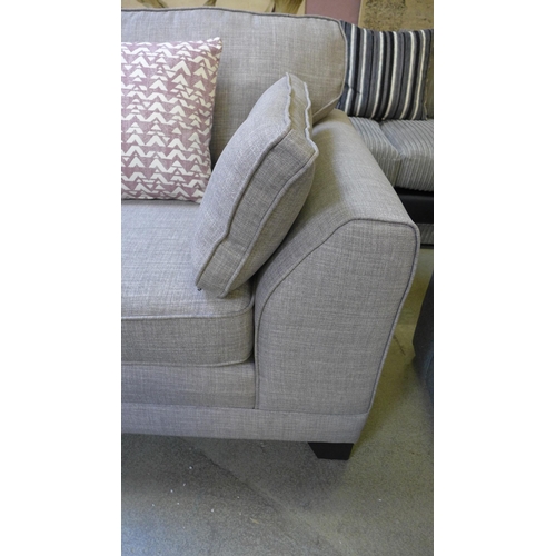 1420 - A light grey upholstered three seater sofa