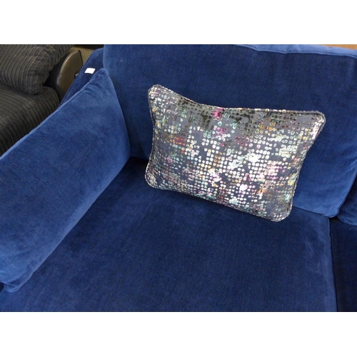 1437 - A blue velvet L shaped sofa with contrasting scatter cushions