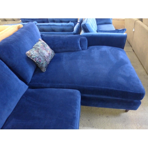 1437 - A blue velvet L shaped sofa with contrasting scatter cushions