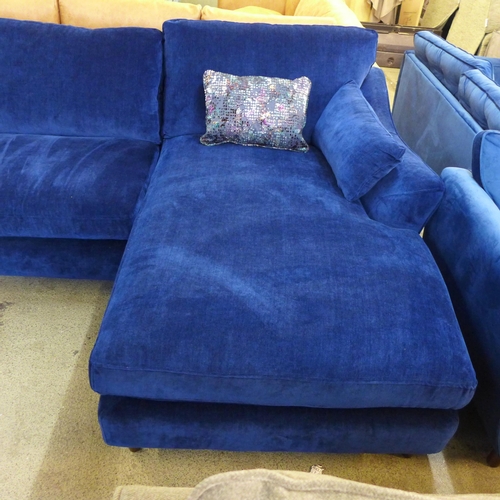 1437 - A blue velvet L shaped sofa with contrasting scatter cushions