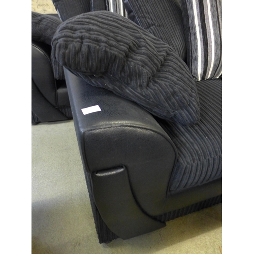 1551 - A pair of  black jumbo cord three and two seater sofas