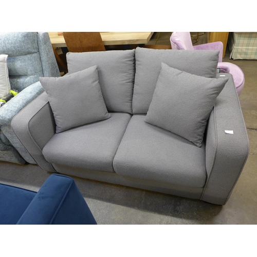 1554 - A grey upholstered three seater sofa