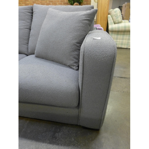 1554 - A grey upholstered three seater sofa