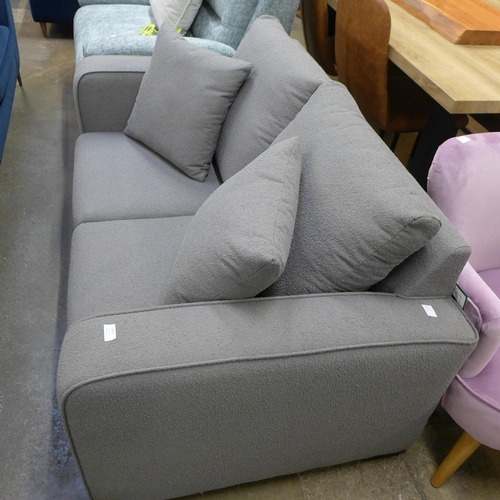 1554 - A grey upholstered three seater sofa