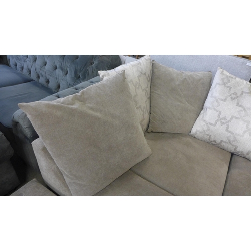 1588 - A sandstone upholstered corner sofa with patterned scatter back cushions