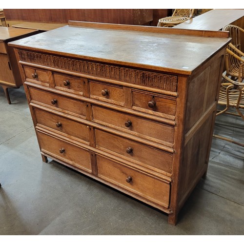 83H - A Heals style oak geometric moulded chest of drawers