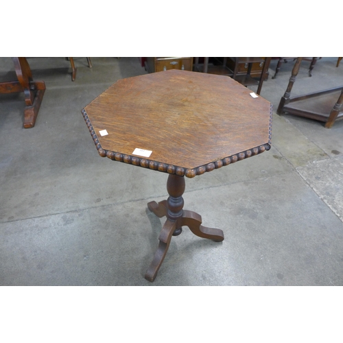 102 - A Victorian oak octagonal tripod table