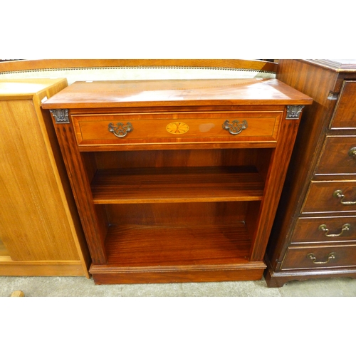 104 - A Regency style inlaid yew wood open bookcase