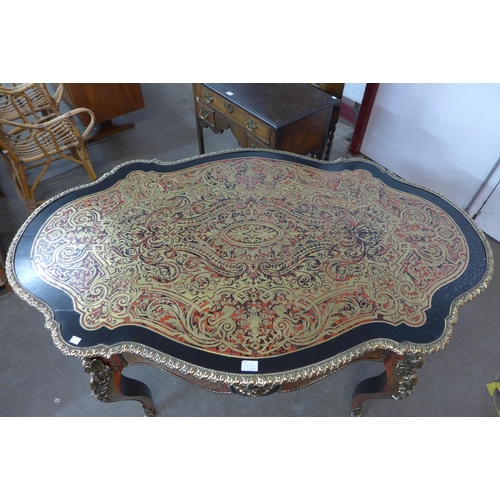 107A - A French Boulle style faux tortoiseshell, gilt metal and ebonised serpentine centre table