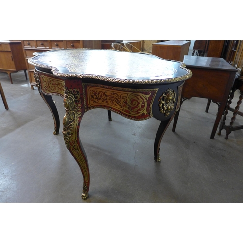 107A - A French Boulle style faux tortoiseshell, gilt metal and ebonised serpentine centre table