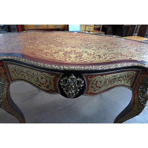 107A - A French Boulle style faux tortoiseshell, gilt metal and ebonised serpentine centre table