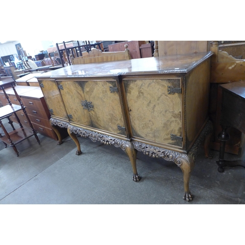 108 - An early 20th Century Queen Anne style carved burr walnut breakfront sideboard, retailed by Harrods,... 