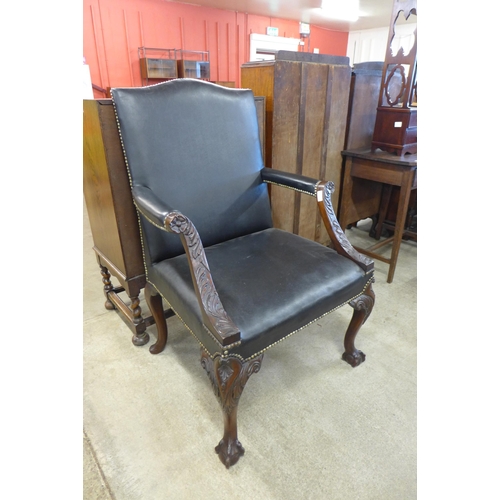 125 - A Chippendale Revival carved mahogany and black leather Gainsborough chair