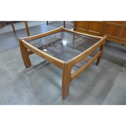 13 - A teak and glass topped square coffee table