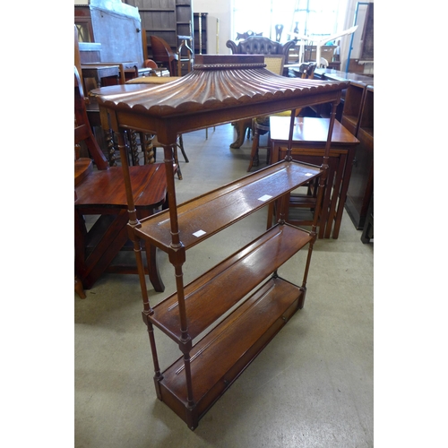 132 - A Regency style mahogany pagoda top three tier wall shelf