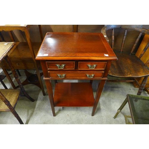 141A - An inlaid mahogany three drawer lamp table