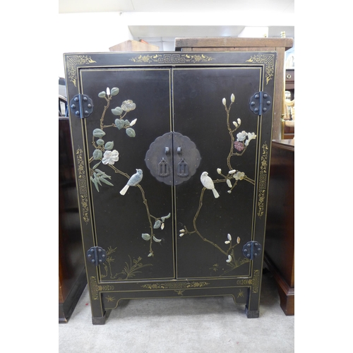 154 - A Chinese black chinoiserie two door cupboard