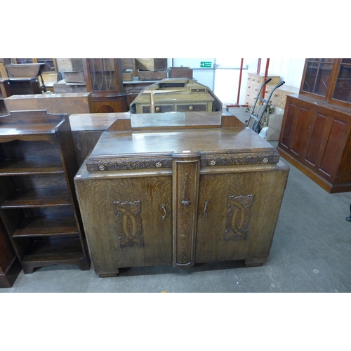 168 - An Art Deco carved oak mirrorback sideboard