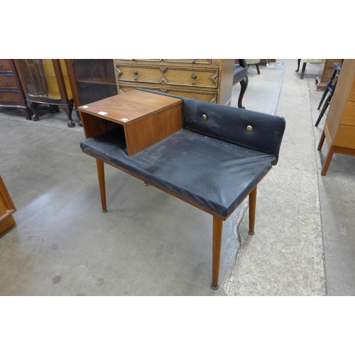 19 - A teak and black vinyl hall seat