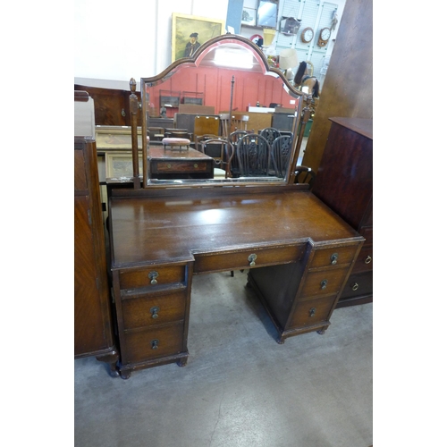 202 - A burr walnut serpentine chest of drawers, a walnut tallboy and an oak dressing table