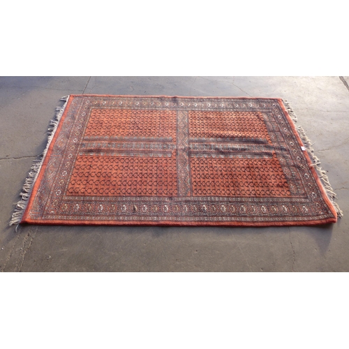 227 - An eastern terracotta ground rug