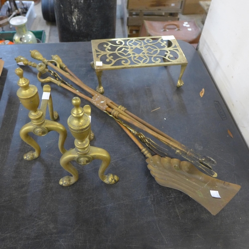 239 - A pair of brass andirons, a brass trivet and a companion set