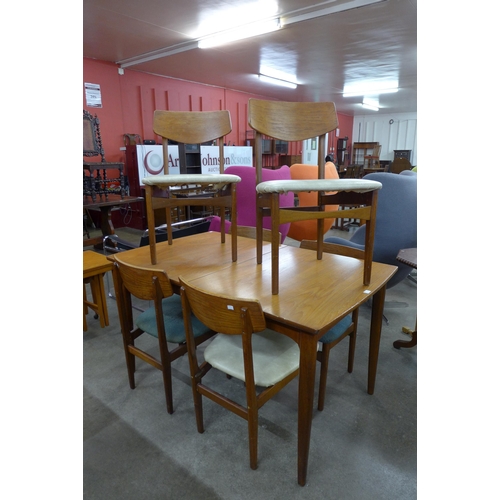 41 - A teak extending dining table and six chairs