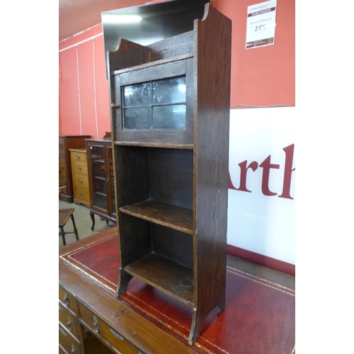 64 - A small Liberty & Co. style Arts and Crafts inlaid oak bookcase