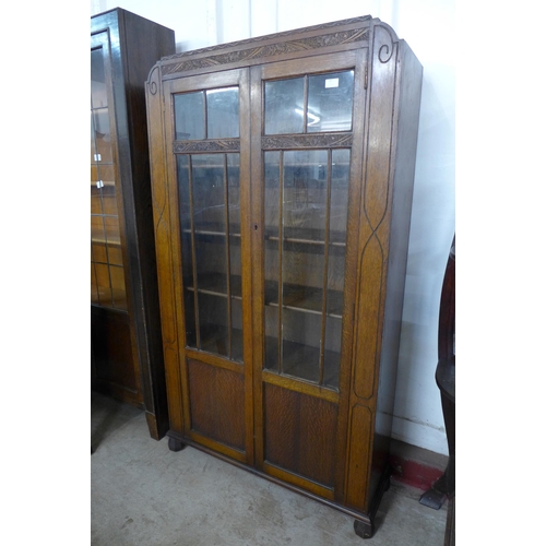 84 - An early 20th Century carved oak two door bookcase