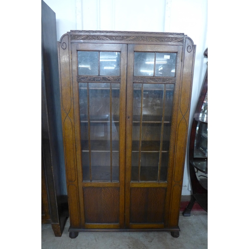 84 - An early 20th Century carved oak two door bookcase