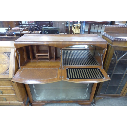 96 - An Art Deco walnut cocktail cabinet