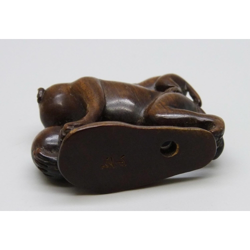 1037 - A carved rosewood netsuke of two monkeys, signed on the base