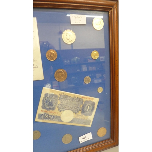 602 - A framed Five Pounds white bank note, two £1 notes, ten shillings note and other coins