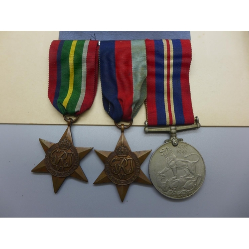 629 - A photograph of a soldier and three WWII medals including the Pacific Star