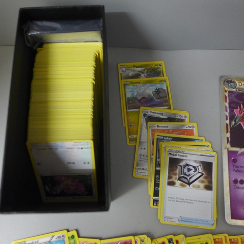 637 - 200+ Pokemon cards with dice, coins, protective sleeves and two large cards