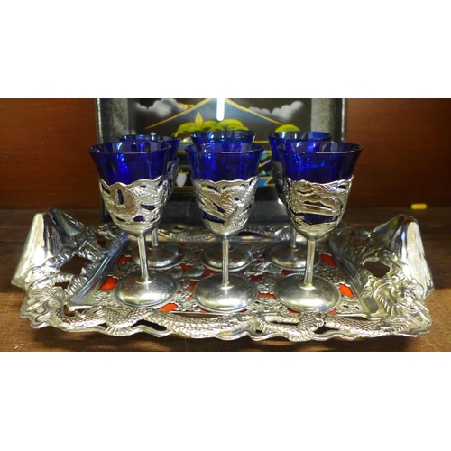 660 - A Chinese pewter and glass drinks set, comprising six goblets with blue glass liner, two large mugs,... 