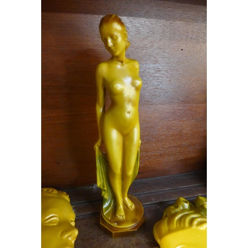 662 - Art Deco style ornamental items, three face masks and a nude figure