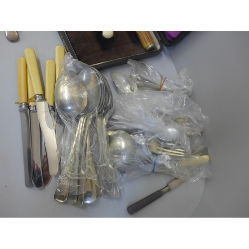 701 - A box of assorted flatware and part carving set