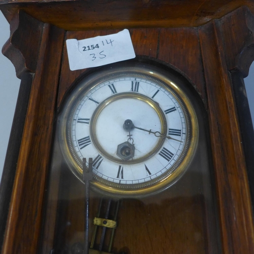 703 - A walnut and ebony small Vienna wall clock